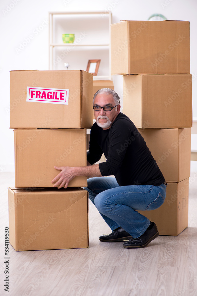 Old male professional mover doing home relocation Old male professional mover doing home relocation