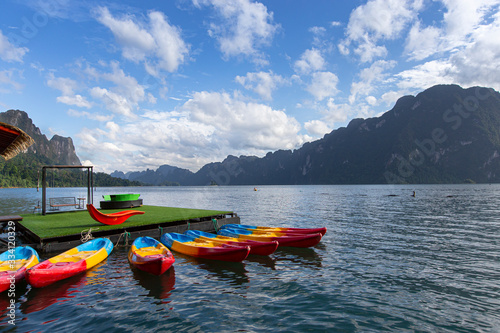 Blue sky with long tail boat floating raft floating at Ratchaprapa Dam ,Surat Thani in Thailand