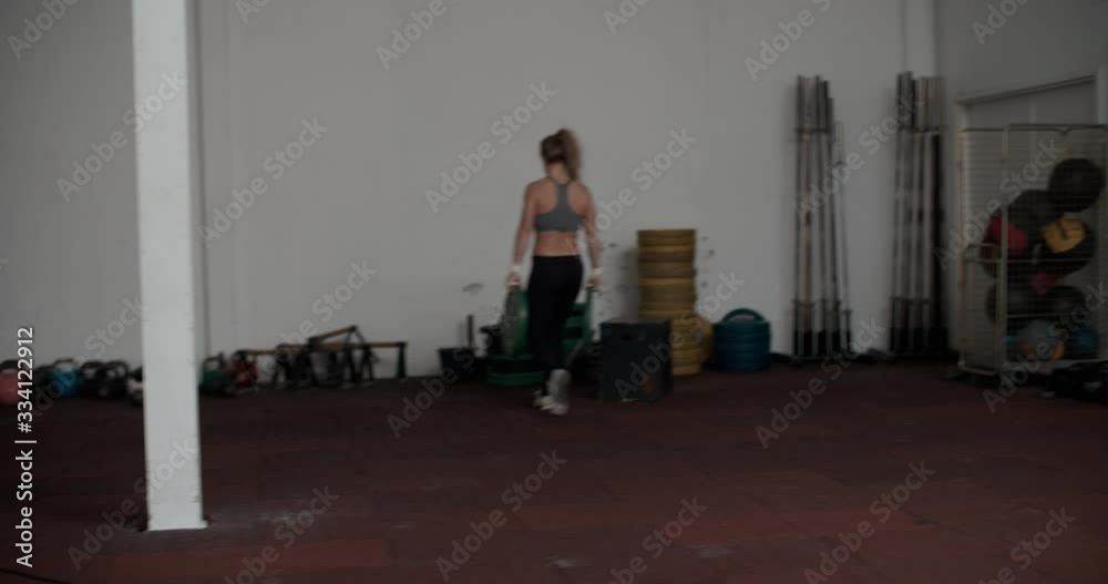 Female Athlete Carrying Heavy Weights