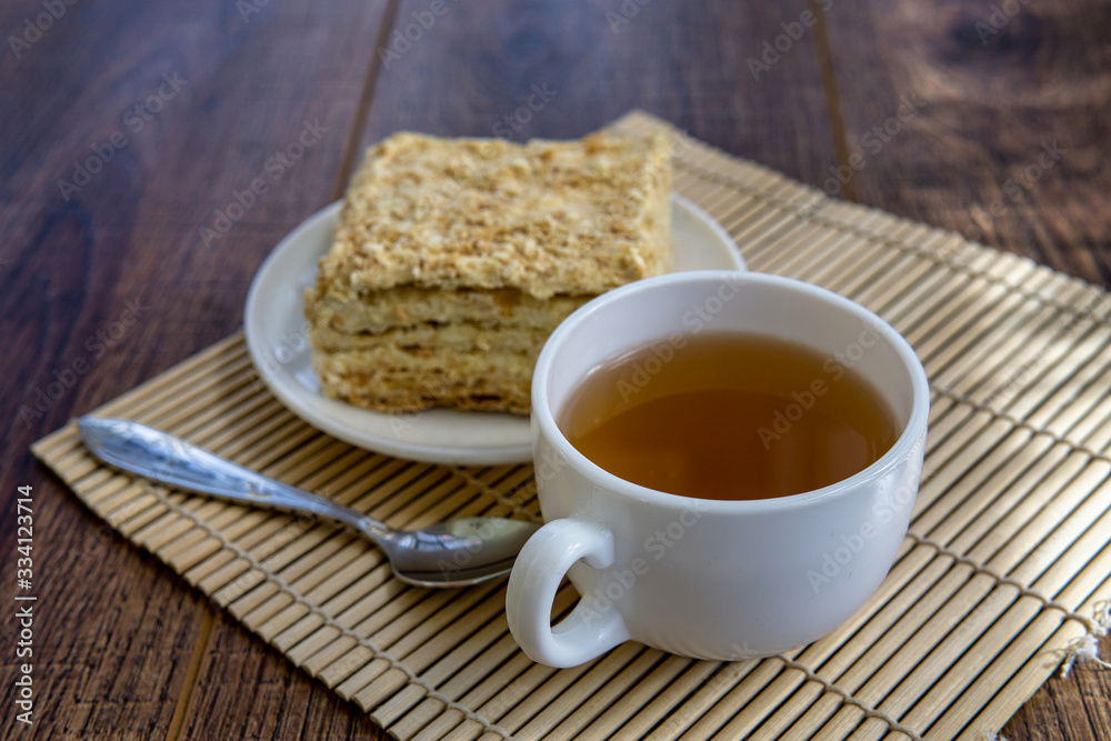 Cup of tea with cake on brown table background Cup of tea with cake on brown table background