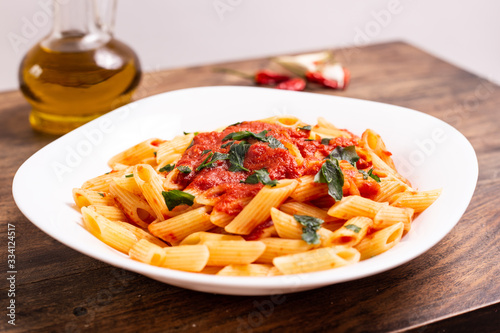 Penne pasta with tomato sauce. Traditional Italian dish, pasta with chili sauce. Italian food.