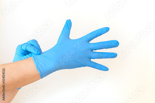 Woman puts on sterile medical gloves