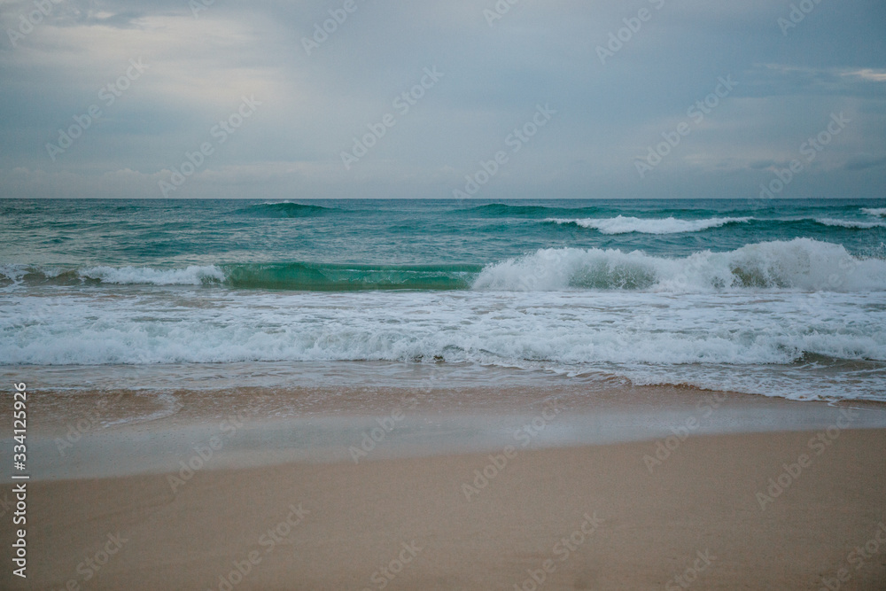 The coast of the Indian Ocean at dawn in Sri Lanka in March 2020. Calm beautiful water and azure blue waves