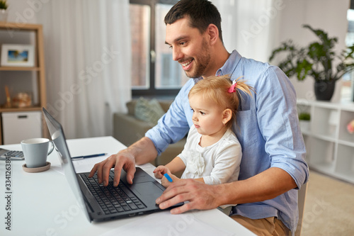 multi-tasking, freelance and fatherhood concept - working father with baby daughter and laptop computer at home office