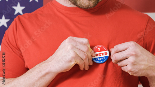 Man putting on I Voted Today button for Presidential election 2020 in America. photo