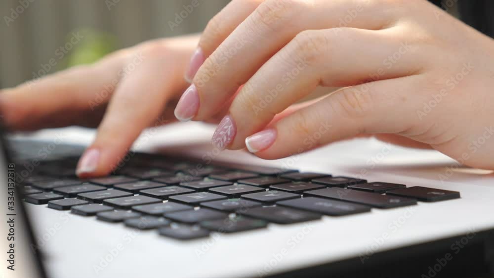 Female fingers typing some text on keyboard of notebook. Unrecognizable woman using laptop outdoors. Girl chatting with somebody or browsing internet. Freelancer working on new project. Dolly shot Female fingers typing some text on keyboard of notebook. Unrecognizable woman using laptop outdoors. Girl chatting with somebody or browsing internet. Freelancer working on new project. Dolly shot