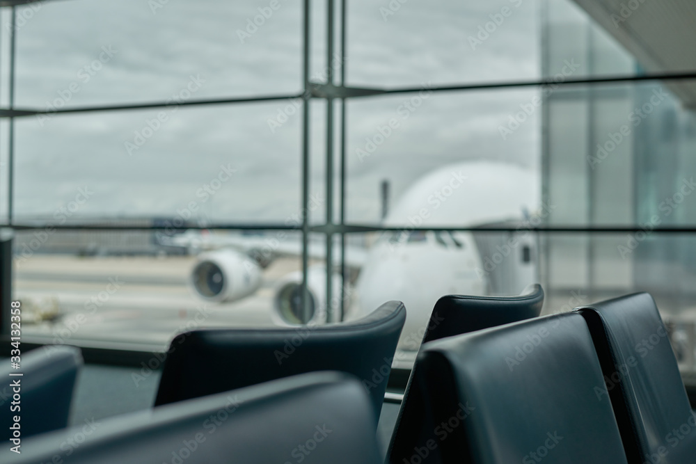 Fototapeta premium Empty airport with blurred plane on a background