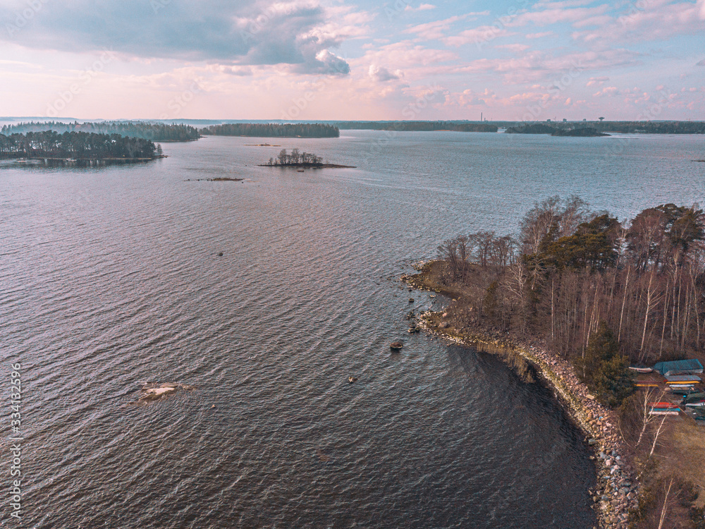 Helsinki islands. Scandinavian sea landscape. Beautiful sunset with reflection of clouds in the sea Aerial top down drone shot.