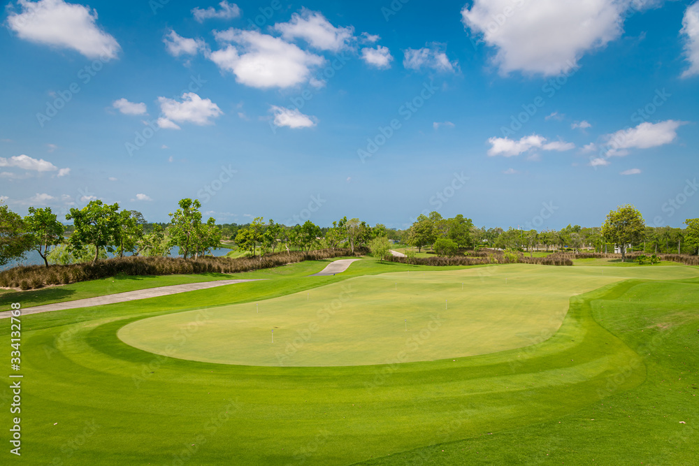 A beautiful view green golf course big tree ,sand bunker and blue cloud sky background. A beautiful view green golf course big tree ,sand bunker and blue cloud sky background.