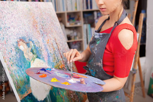 Cropped shot of a female artist mixing oil paint on a palette. Inspiration, creativity concept