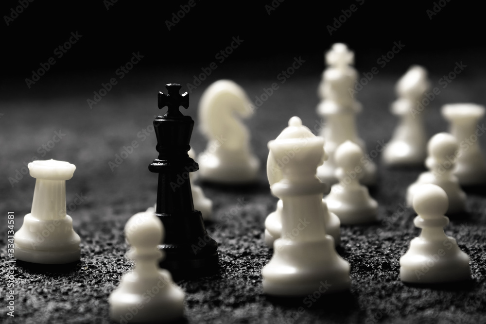 black king surrounded by enemies ambush on black concrete dark background .copy space black king surrounded by enemies ambush on black concrete dark background .copy space