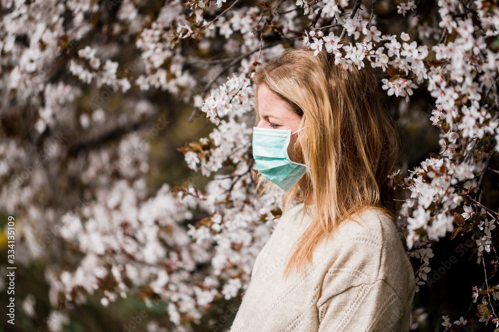 Woman in mask in - enjoy corona virus quarantine in the garden Woman in mask in - enjoy corona virus quarantine in the garden