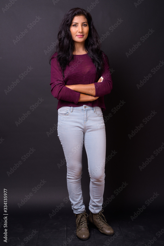 Full body shot of young beautiful Indian woman with arms crossed Full body shot of young beautiful Indian woman with arms crossed