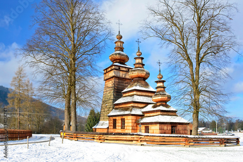 Ancient greek catholic wooden church in Kwiaton village at winter time - a classic example of Lemko church architecture, UNESCO, Low Beskid (Beskid Niski), Poland