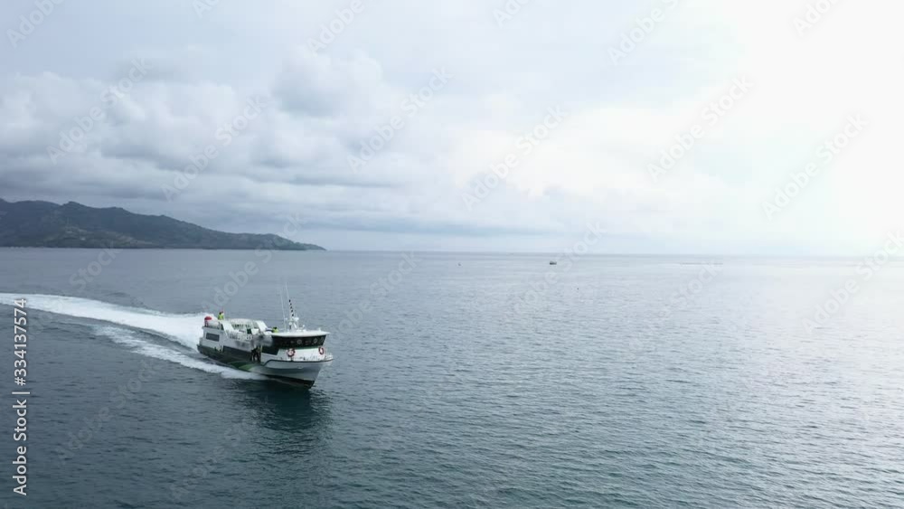 Weekender from drone beautiful weather with calm sea and sun shining. Top view from above boat anchored yacht floating in ocean runabout or cruiser stands in azure sea waters with coral reef visible. Weekender from drone beautiful weather with calm sea and sun shining. Top view from above boat anchored yacht floating in ocean runabout or cruiser stands in azure sea waters with coral reef visible.