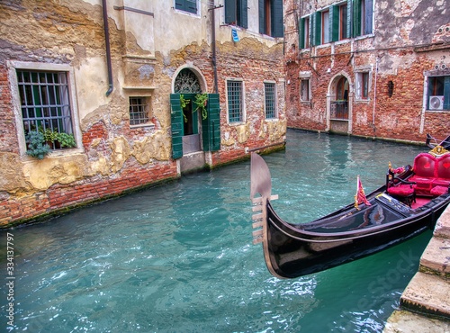 Gondola sailing through a canal in Venice.