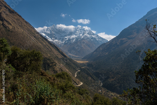 Rocky paths and green valleys surrounded by snowcapped mountains on the Salkantay Trek, Peru