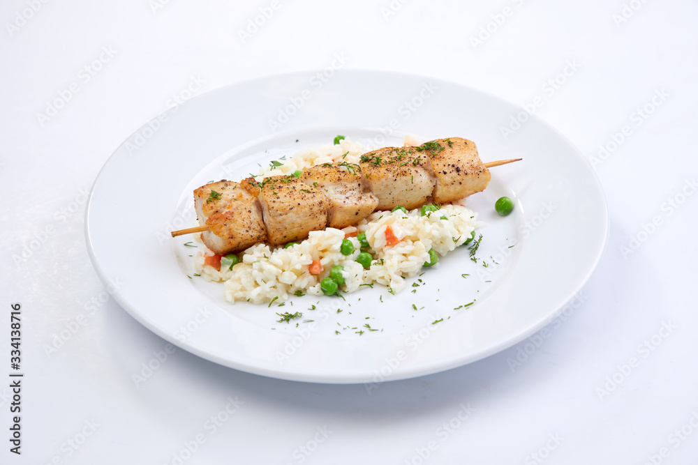 chicken kebab with rice and vegetables on the white background chicken kebab with rice and vegetables on the white background