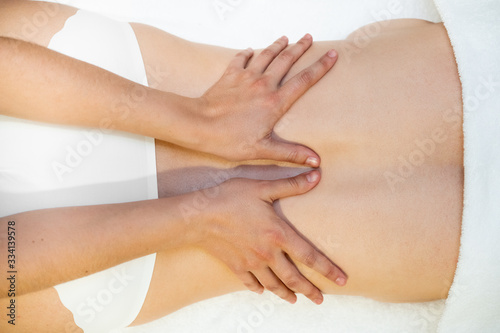 Young woman receiving a back massage in a spa center