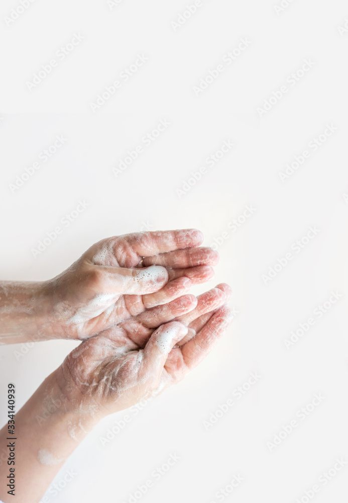 The baby's soap hands on a light background. The baby's soap hands on a light background.
