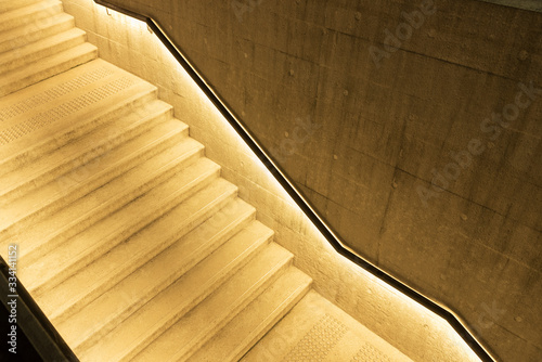 Wall Mural Empty stairway with illuminated bannister in modern architecture