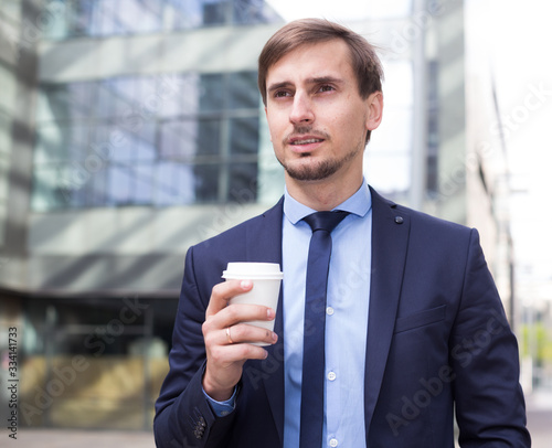Businessman in suit with cup of coffee