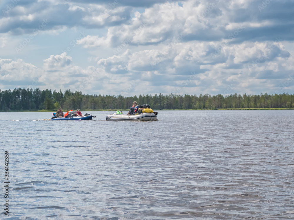 Landscape of harsh Karelian nature with kayak in lake. Active extreme ecotourism in Karelia. Water rafting in North lakes