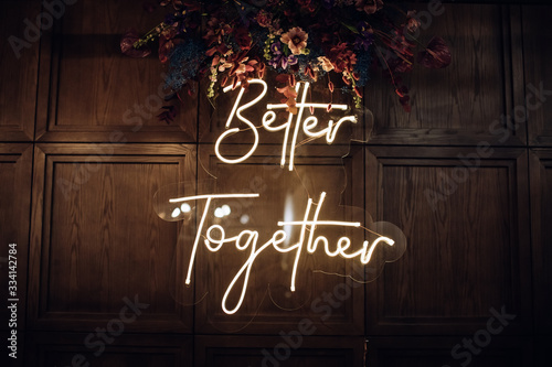 Better Together - neon sign on a brick wall in a restaurant at a wedding party. Love concept	