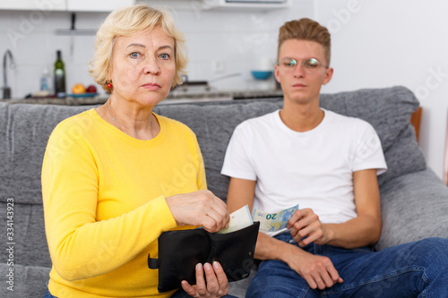Woman giving money her adult son