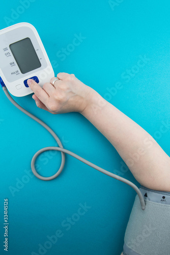 Measurement of blood pressure using a medical electronic automatic tonometer. A blood pressure monitor measures the pressure on a woman