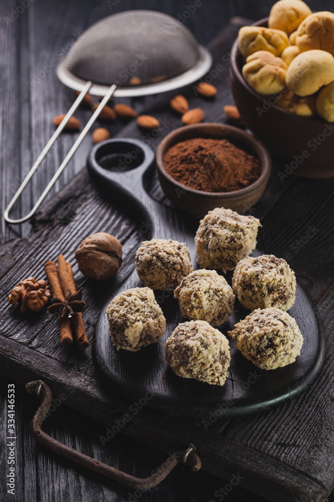 Delicious homemade chocolate chip cookies balls on a black wooden background.