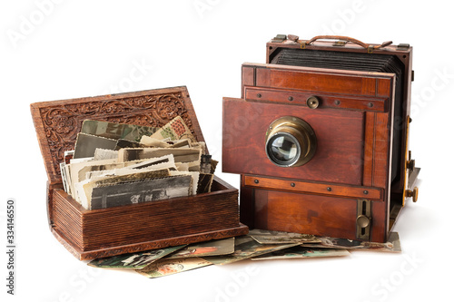 Vintage film photo-camera and old family photos.