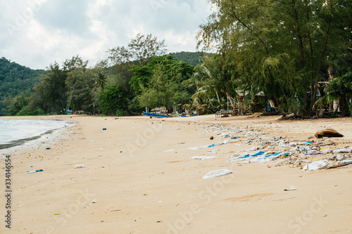 Beach pollution. Plastic bottles and other trash on the beach