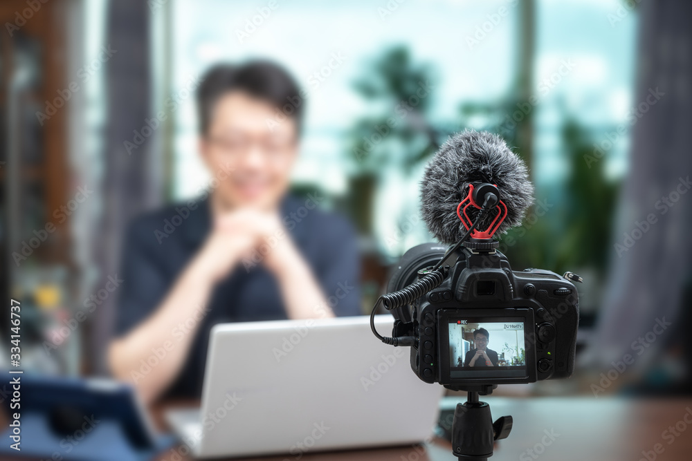Online lecture concept. Asian middle-aged man giving online lectures at home. Online lecture concept. Asian middle-aged man giving online lectures at home.