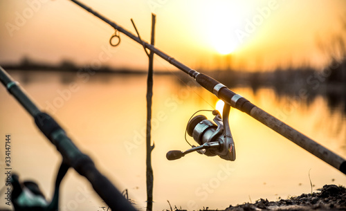 carp fishing reel isolated on sunset light