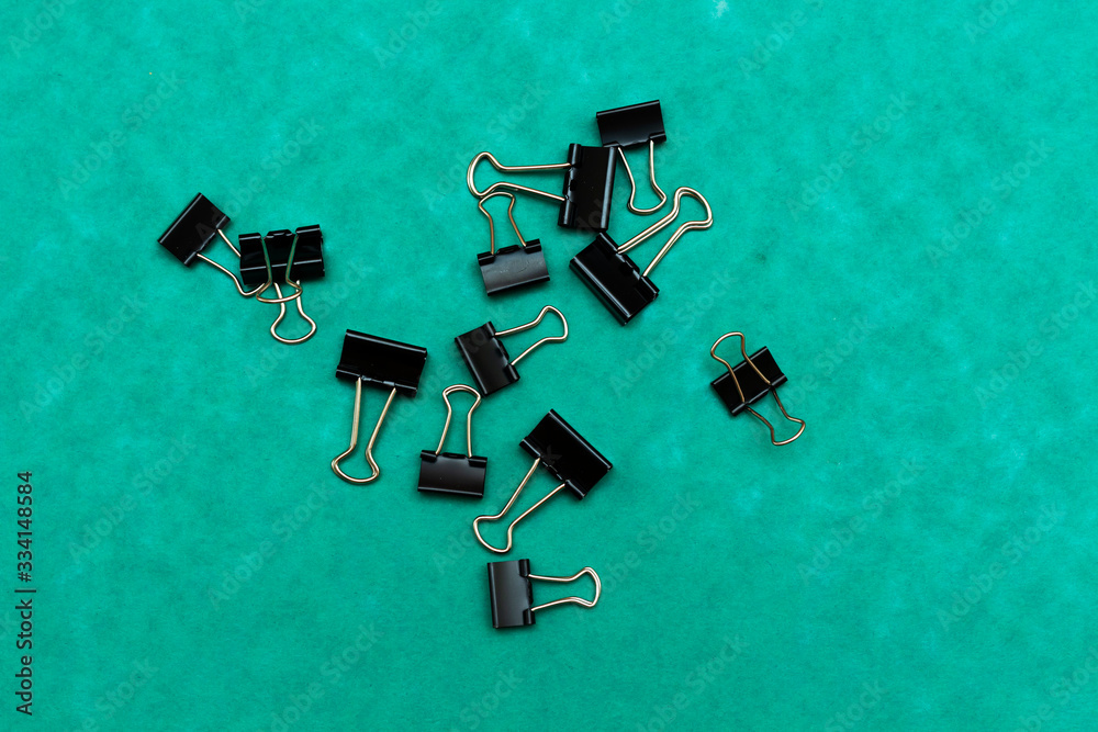 bulldog paperclips isolated on green background