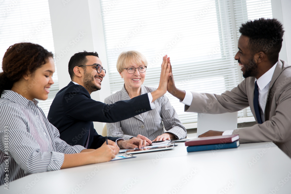 Happy overjoyed professionals multy-ethnic group rejoice victory