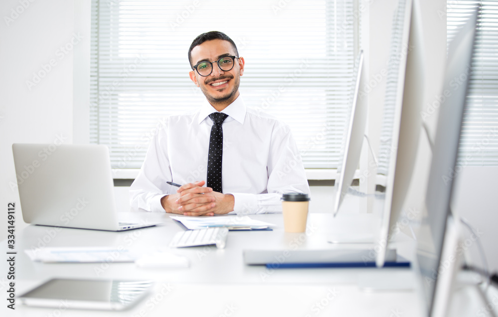 Portrait of arab businessman looking at camera at workplace in an office