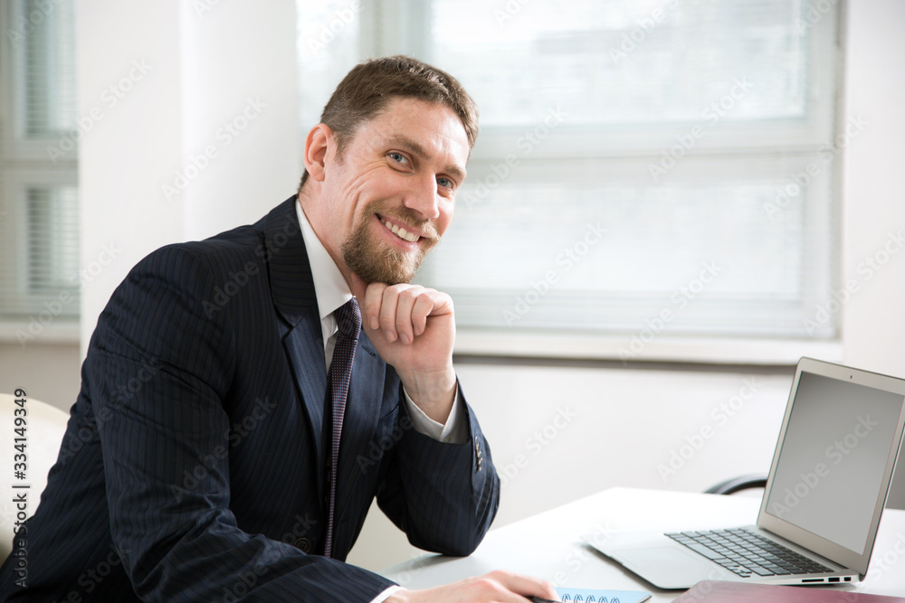 Young businessman working with laptop at office