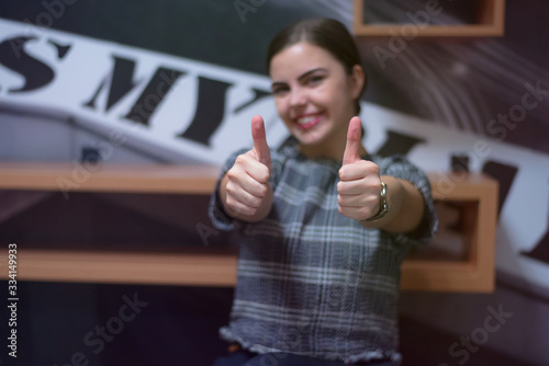 Young business woman with finger up showing business project like woman as leader.
