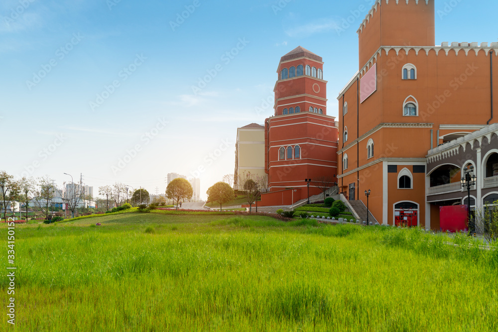 Grass and Mediterranean-style buildings in a shopping center Grass and Mediterranean-style buildings in a shopping center