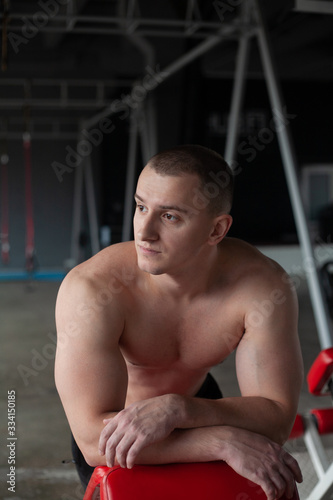Fototapeta Naklejka Na Ścianę i Meble -  young man exercising in gym