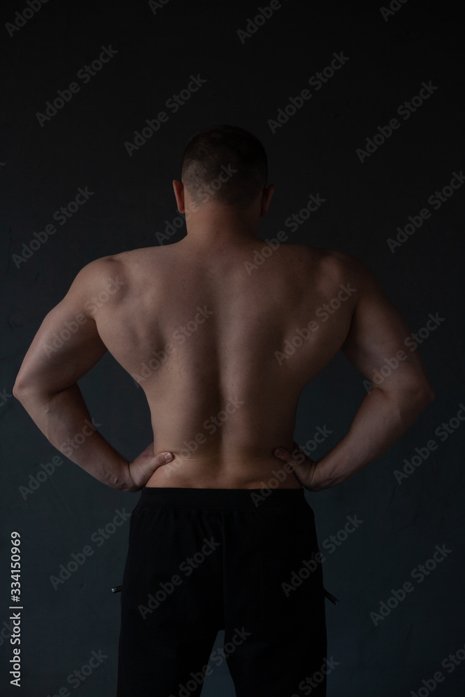 Fototapeta premium athletic guy strains his back