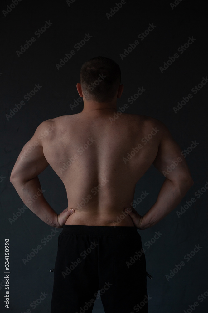 Fototapeta premium athletic guy strains his back