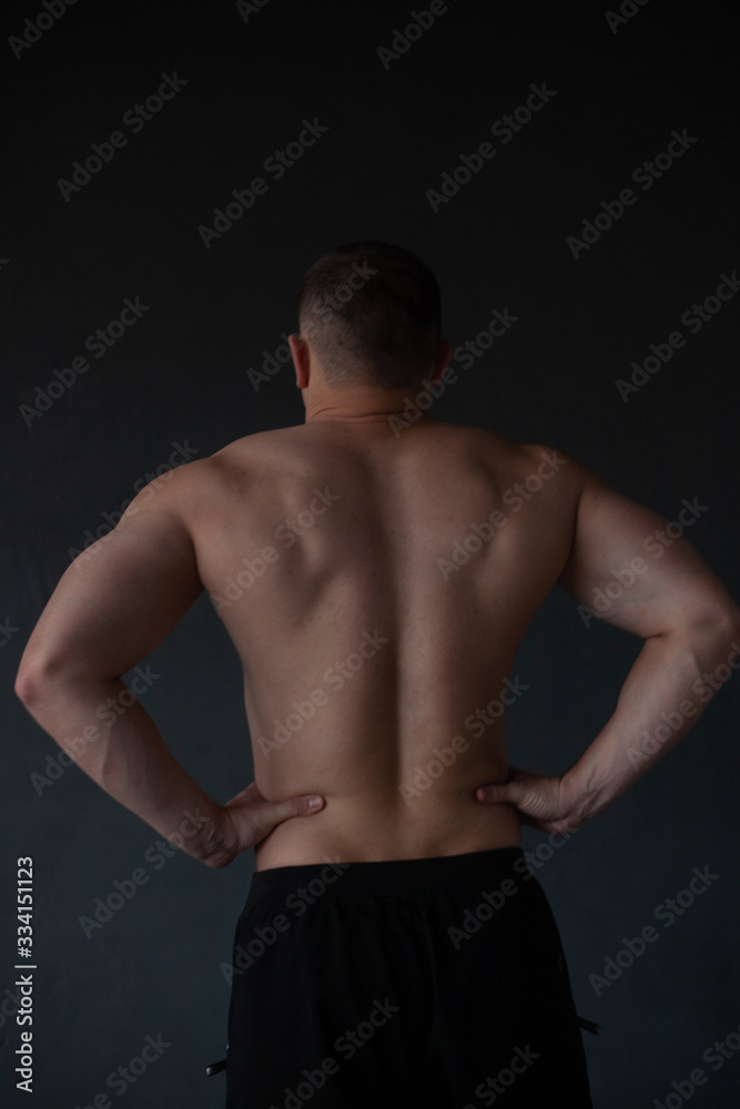 Fototapeta premium athletic guy strains his back