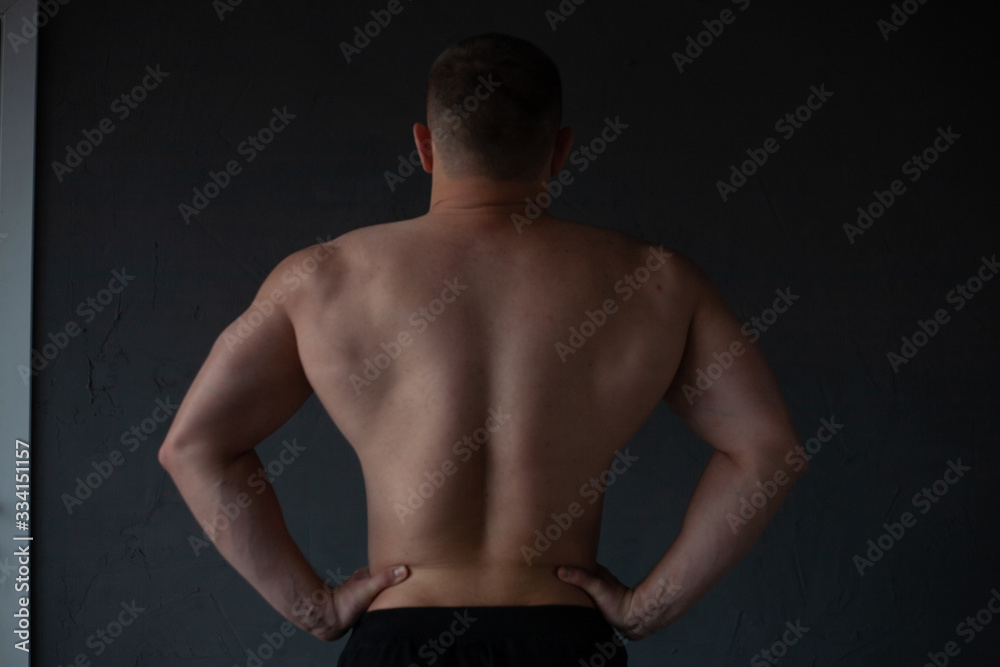 Fototapeta premium athletic guy strains his back