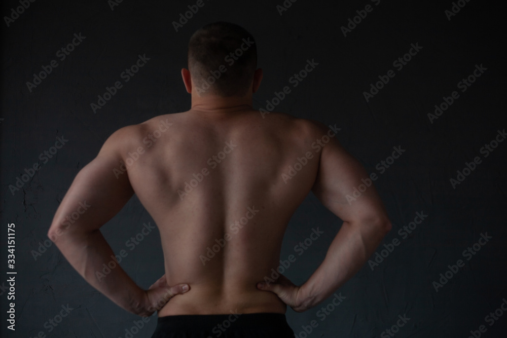 Naklejka premium athletic guy strains his back