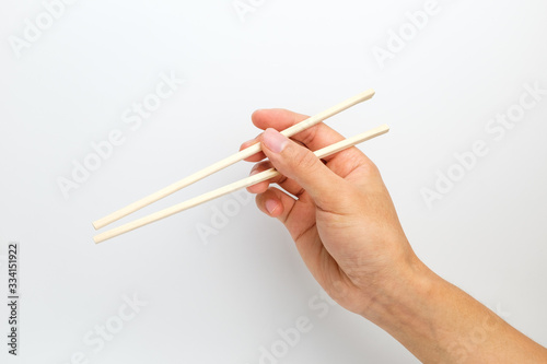 Disposable wooden chopsticks on white background