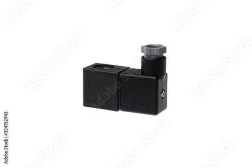 Black solenoid coil with plug socket for control valve, isolated on white background
