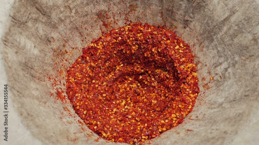 Slow-motion video of cooks pounding chili paste By using a mortar and pestle larger than normal to pound the chilli thoroughly Which is a way of life for rural villagers in Thailand.